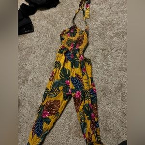 Colorful open back floral yellow jumpsuit. Size medium.